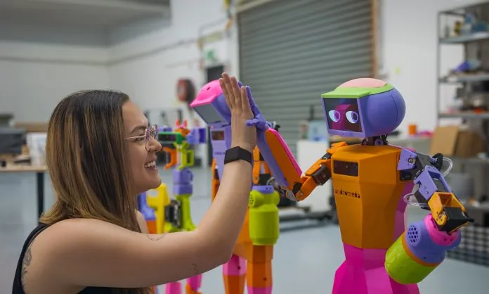 Andromeda Co-founder Grace Brown with Abi the robot.